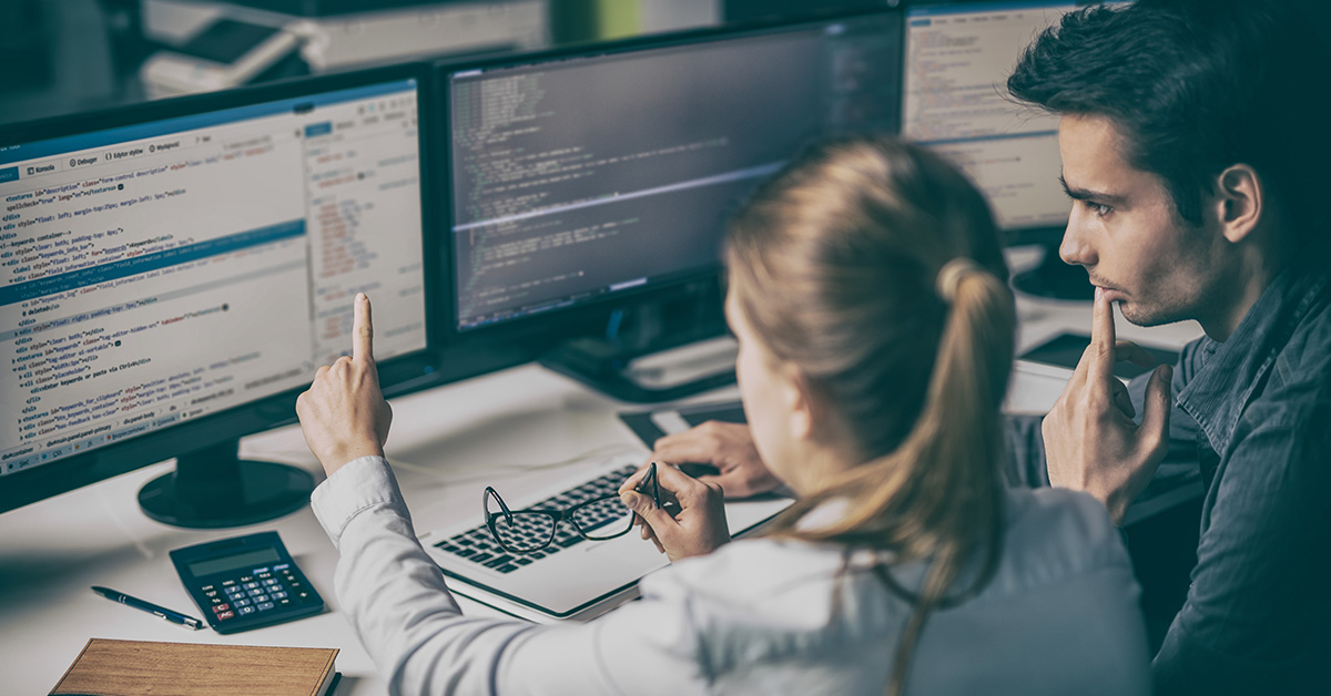 Developers looking at code designing website
