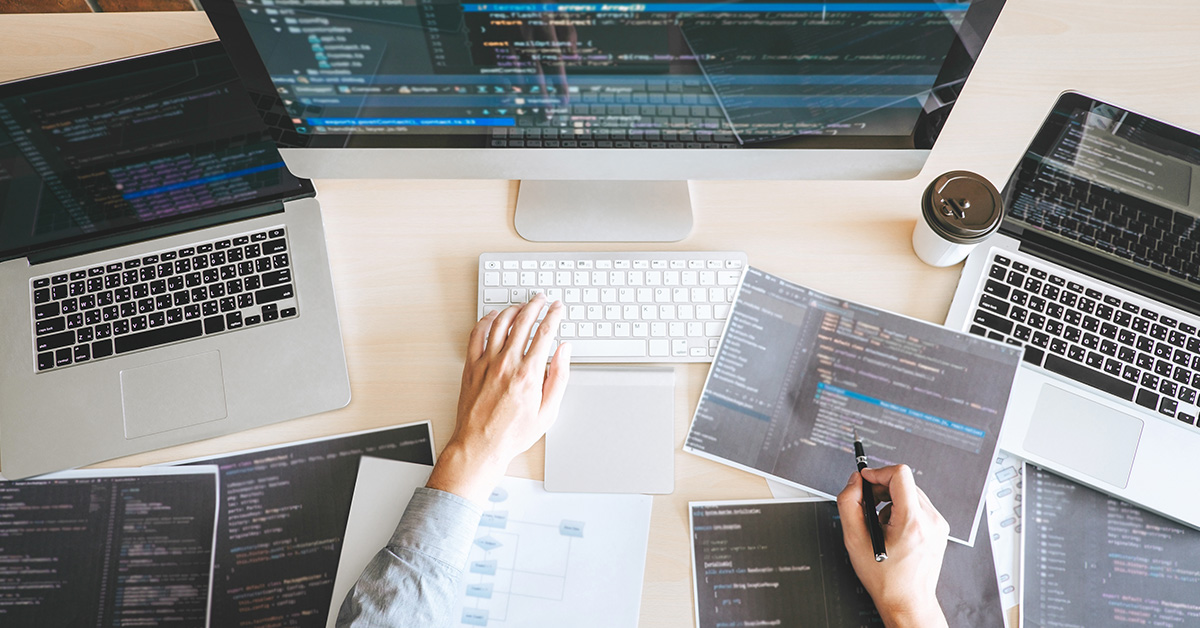 Developer with multiple screens making website