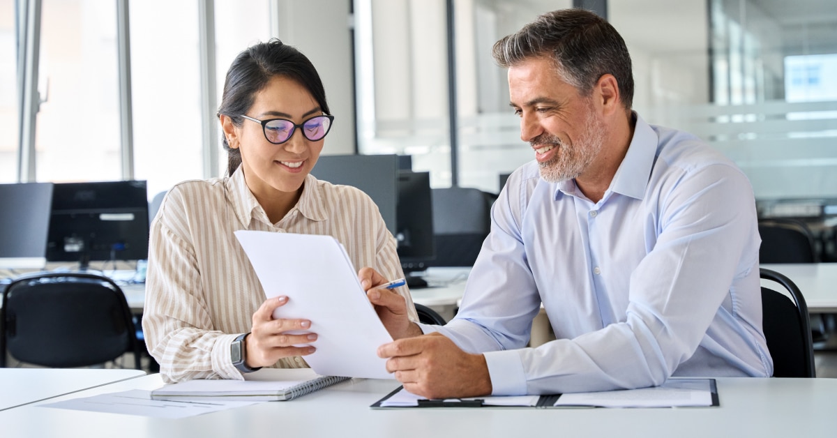 two people reading sales report sitting by the table