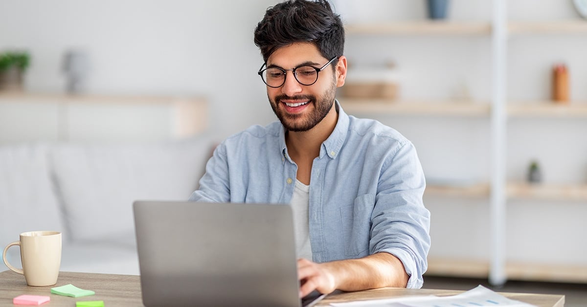 men working on the computer smiling