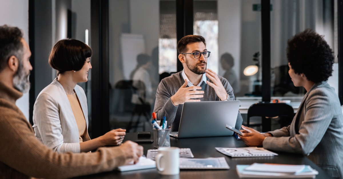 Four people sitting around a conference table